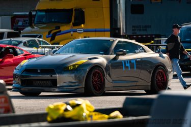 Full three-quarter view of Mike's GTR parked next to other race cars