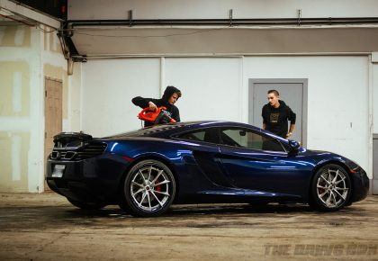 Chris and Anthony drying water droplets off the cleaned McLaren