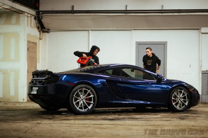Chris and Anthony drying water droplets off the cleaned McLaren