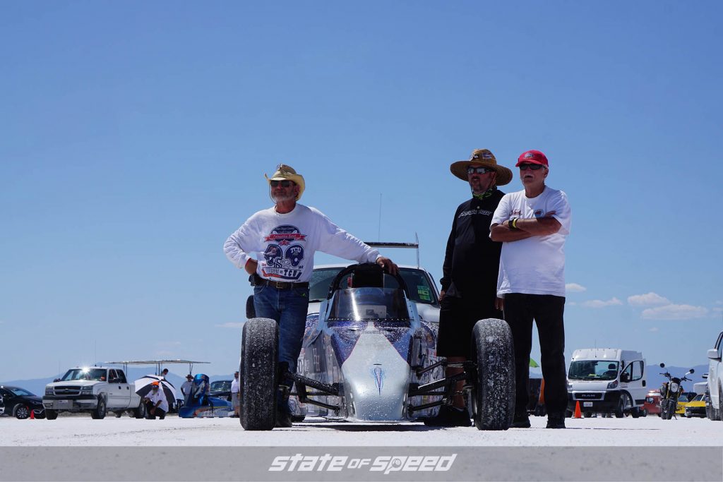 Race team next to their roadster