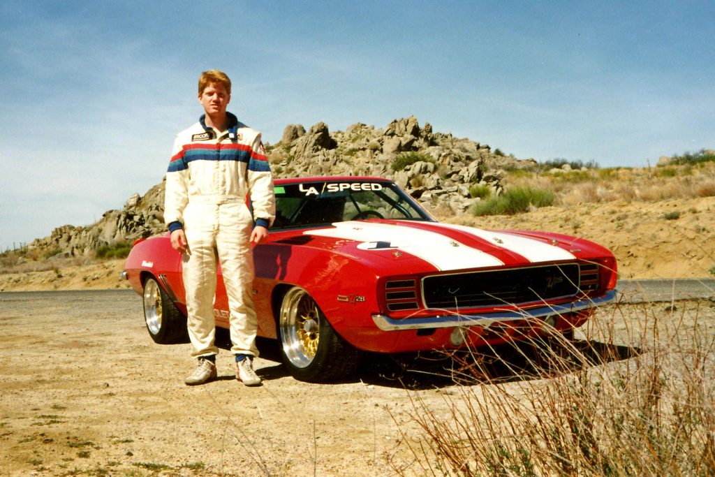 RJ standing next to the Big Red Camaro