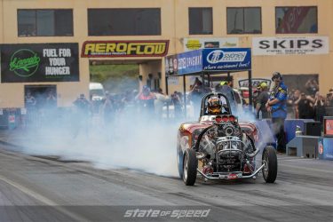 Drag racing car fishtailing off of the line