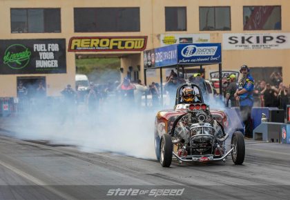 Drag racing car fishtailing off of the line