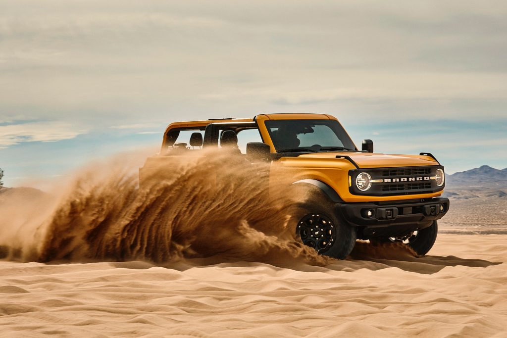 Orange Yellow 2021 Ford Bronco in running in the desert sand