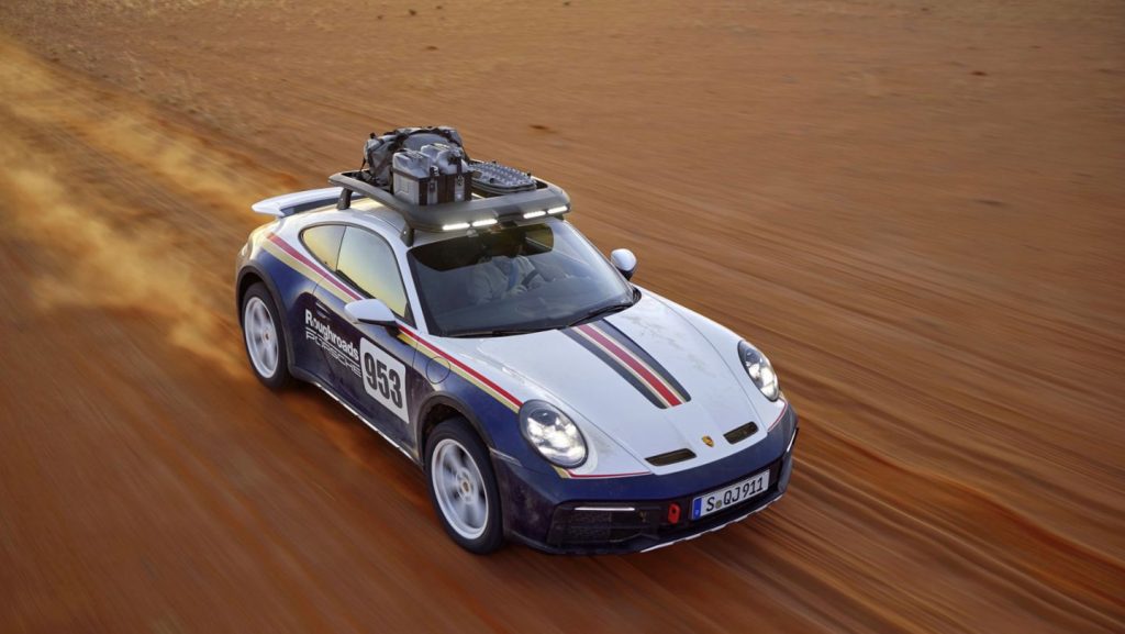 2023 Porsche 911 Dakar with racing stripes in a desert