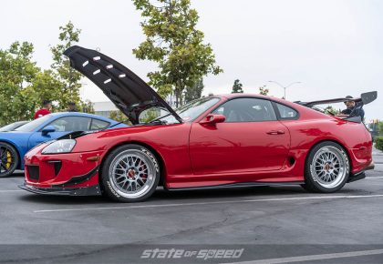 red toyota supra with hood open
