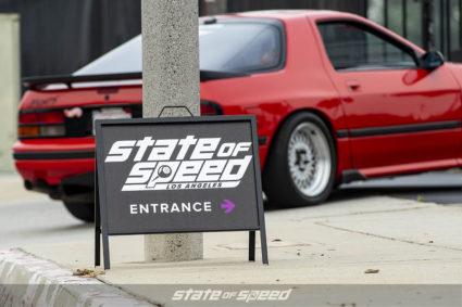 State of Speed Los Angeles LA entrance sign with red Mazda RX-7