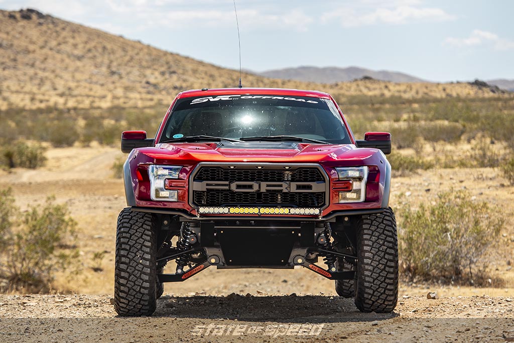 Red Ford F-150 Raptor gen 2 modified by SVC in a desert 