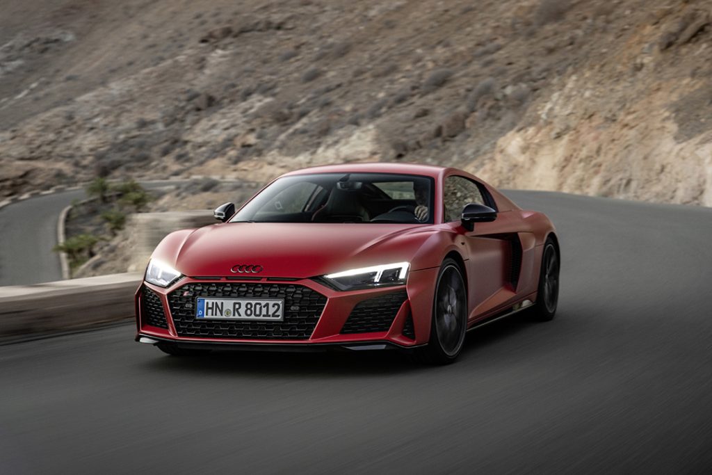 tango red Audi R8 Coupé V10 performance RWD on a mountain road