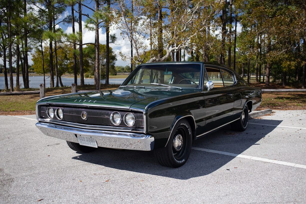 dark green '66 dodge charger in forest