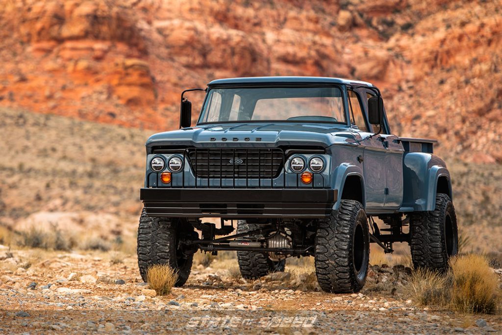 Blue 1968 Dodge W300 with Milestar Patagonia M/T tires on some rocks