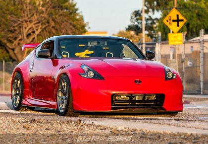 Red Nissan 370Z on train tracks