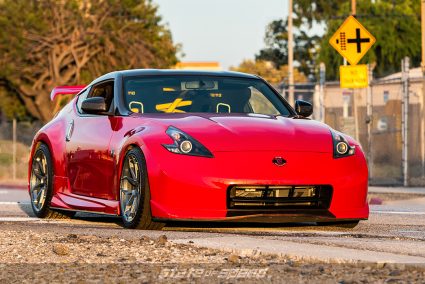 Red Nissan 370Z on train tracks