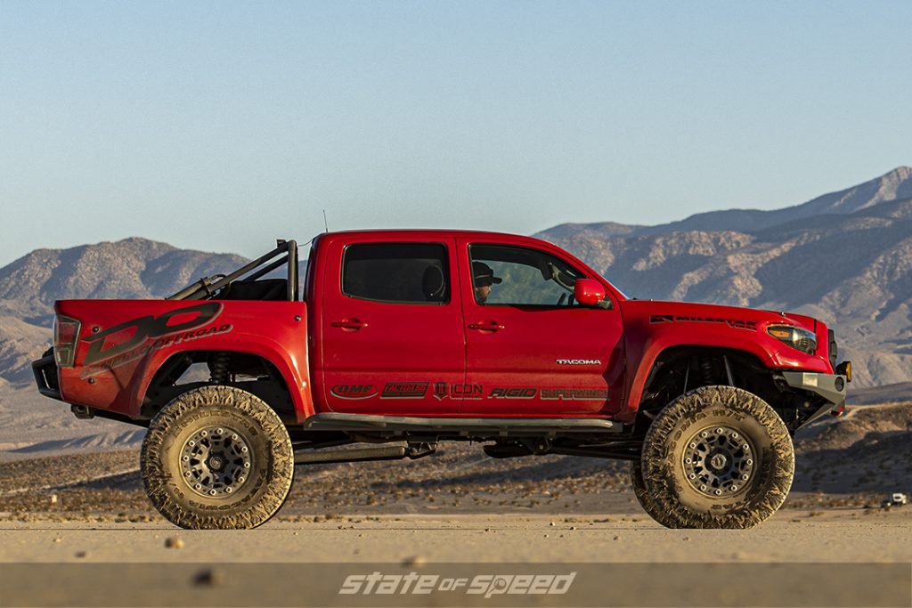 custom Red 2005 toyota tacoma by demello side view in a desert