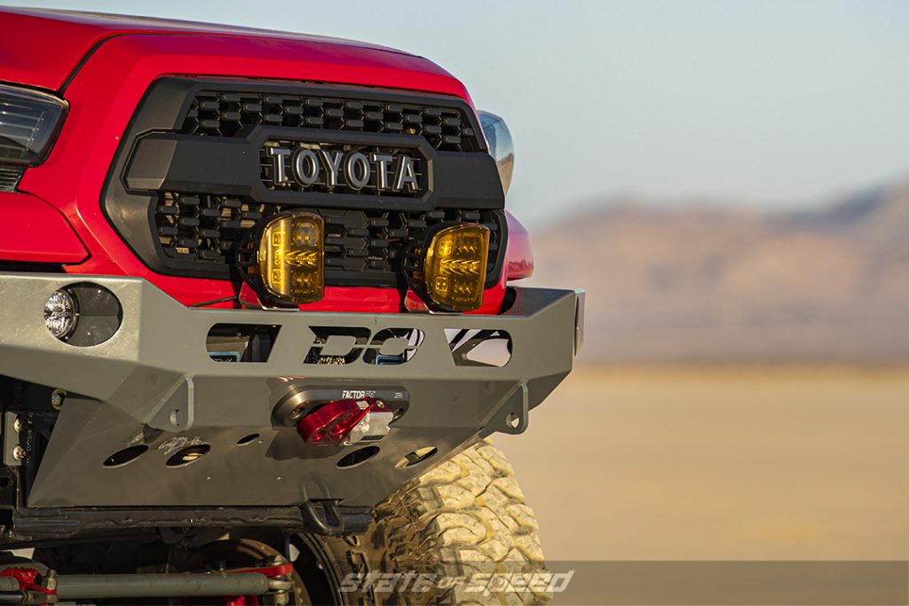 close up of a Demello front bumper on a red toyota tacoma 