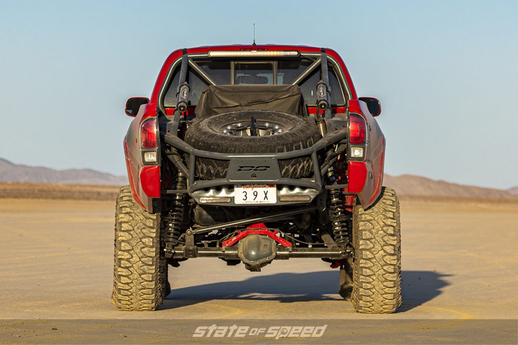 rear of a red toyota tacoma in a desert