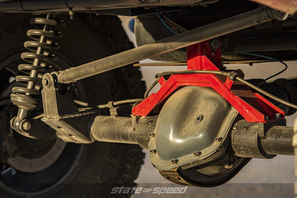solid axle suspension on red toyota tacoma