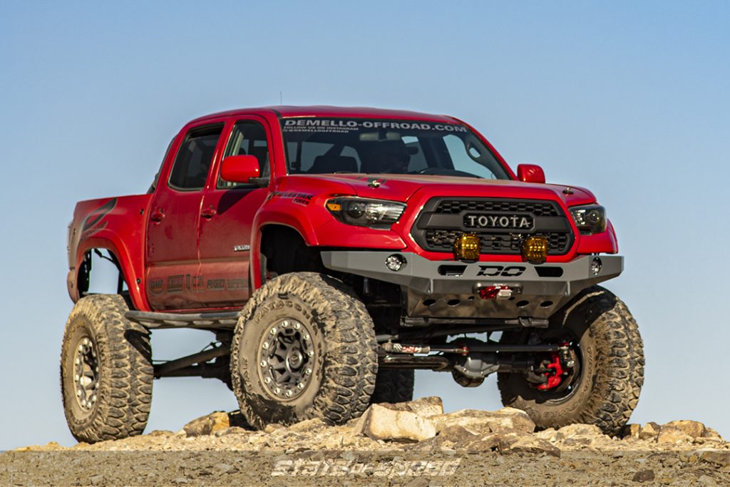 red toyota tacoma on a hill