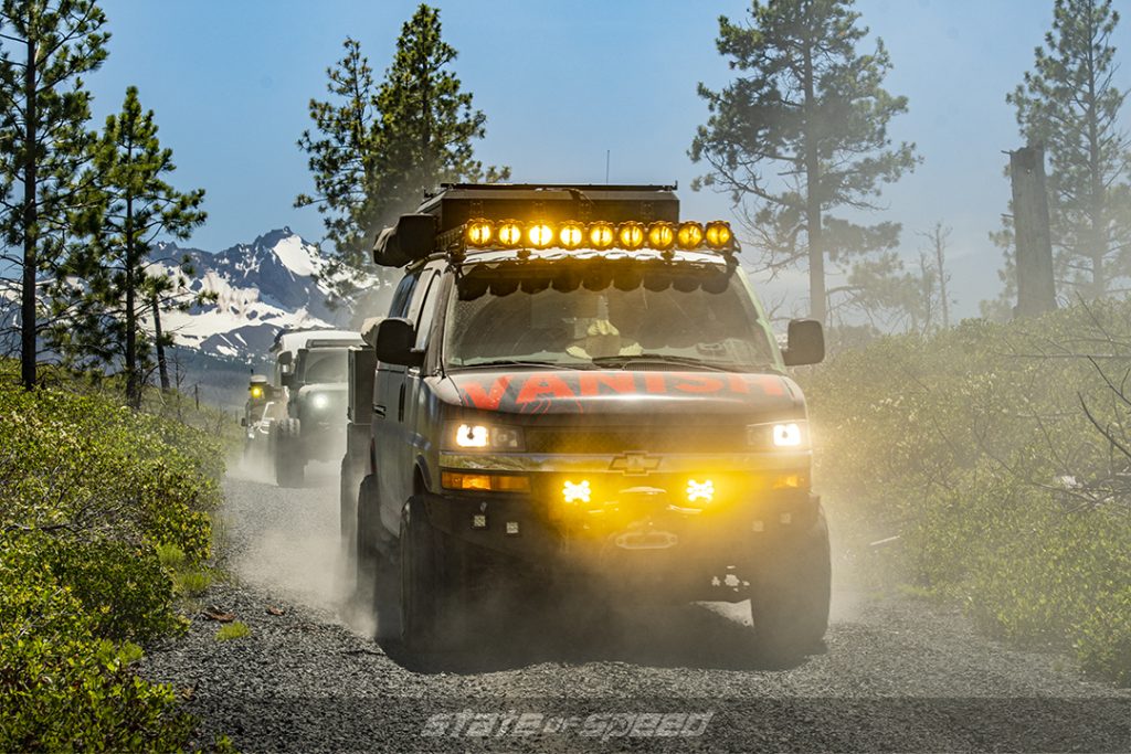 gray chevrolet on a gravel road followed by a jeep in Deschutes National Forest