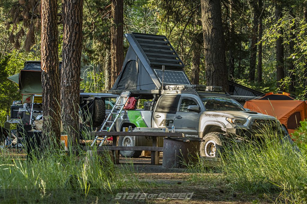 gray toyota tacoma overlander set up to camp 