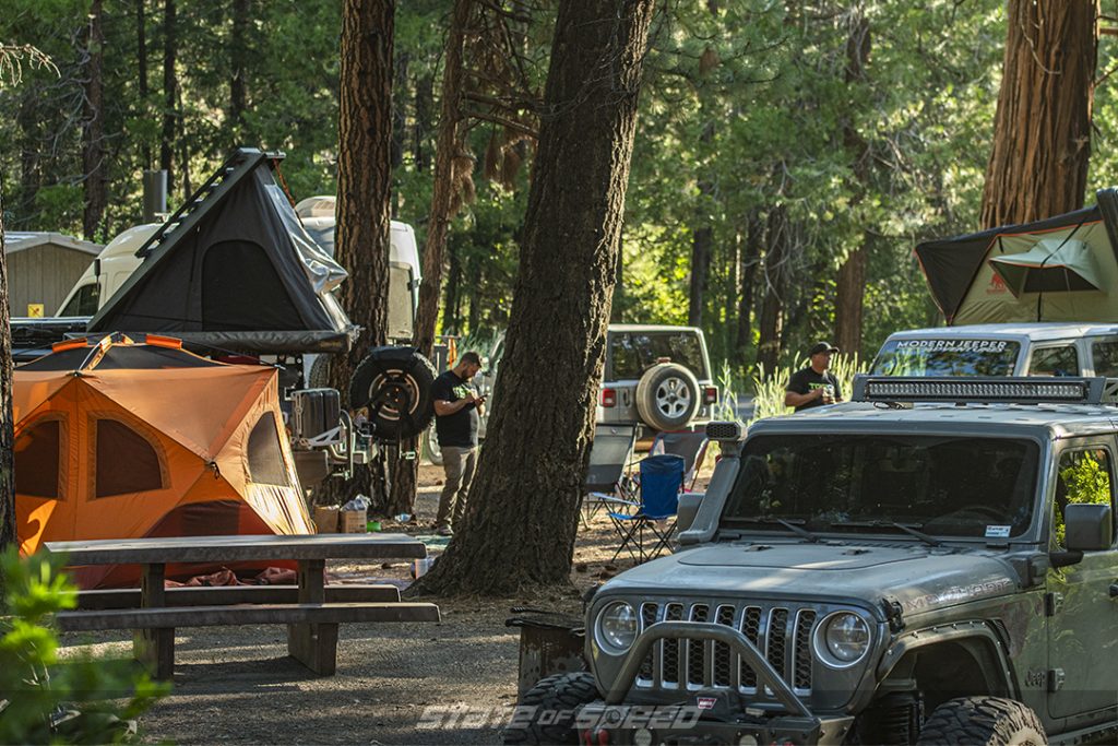 gray and white jeep overlanders set up camp