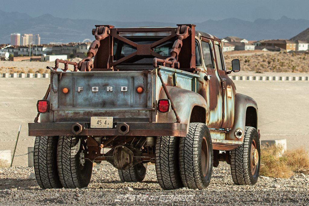 rear of hodson motors custom ford f600 dually in desert on patagonia tires