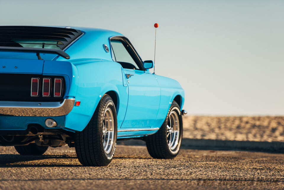 Detailed side shot of the Blue 1969 Mustang Mach 1 parked at the beach