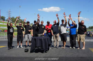 Racers showing off trophies