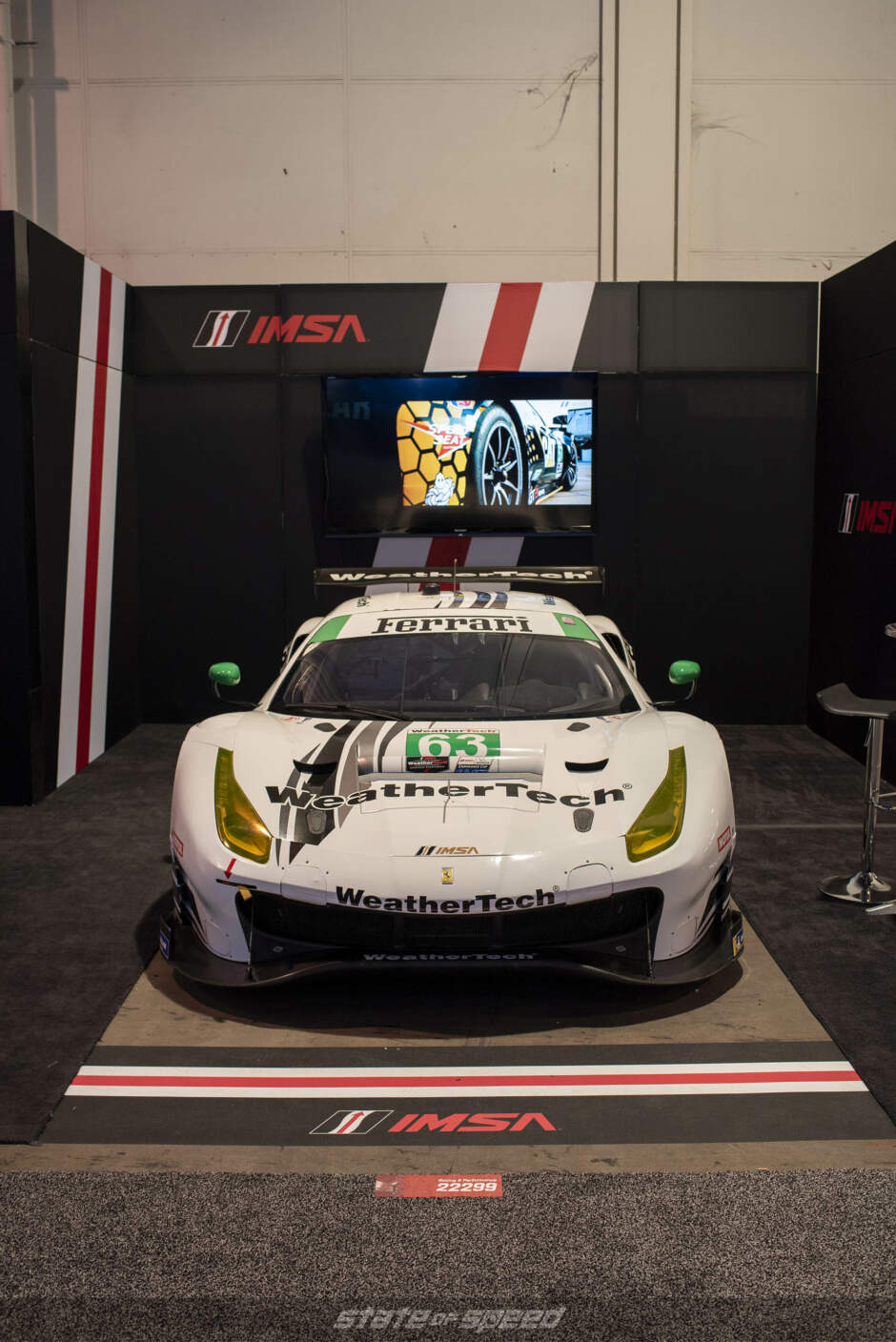 IMSA Racing booth showcasing Weathertech Ferrari GT car