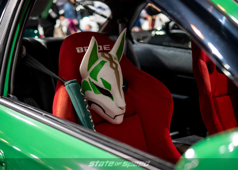 interior of a ek9 honda civic hatchback featuring bride seats and a wolf mask