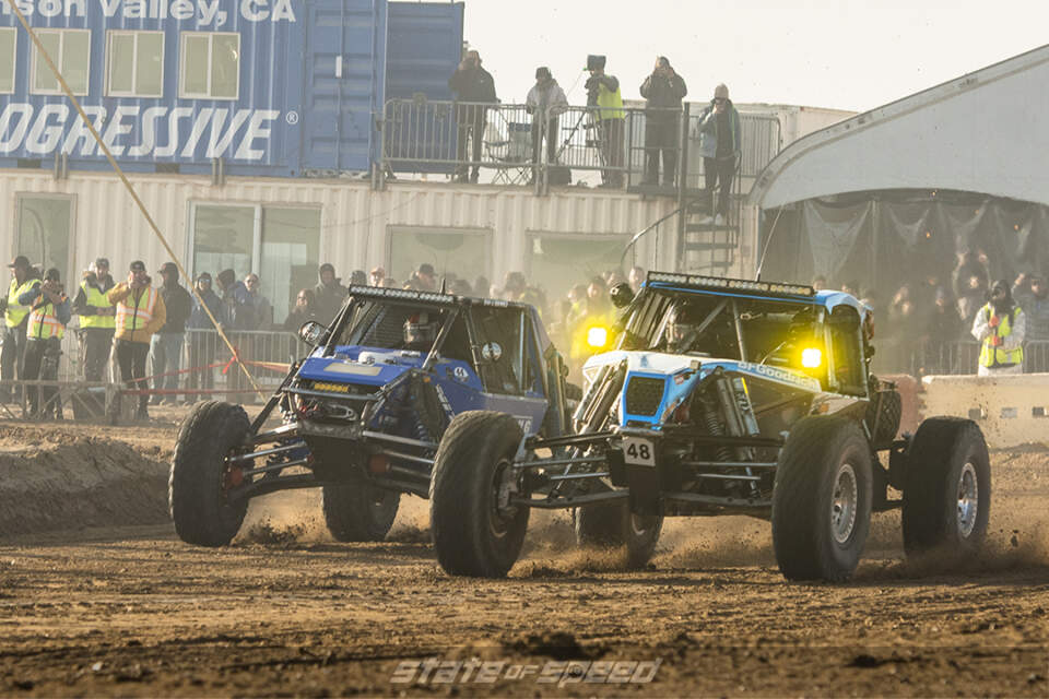 2 desert racers taking a corner side by side at King of the Hammers 2022